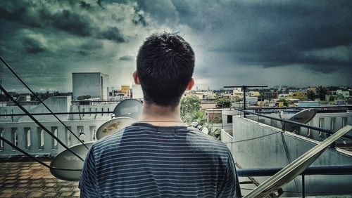Silhouette of man standing against cloudy sky