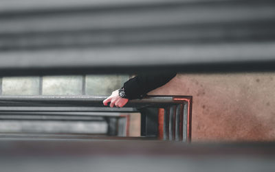 Close-up of person hand on window