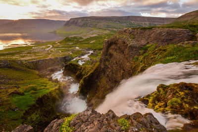 Scenic view of waterfall against sky