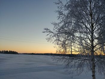 Scenic view of frozen lake against sky during winter