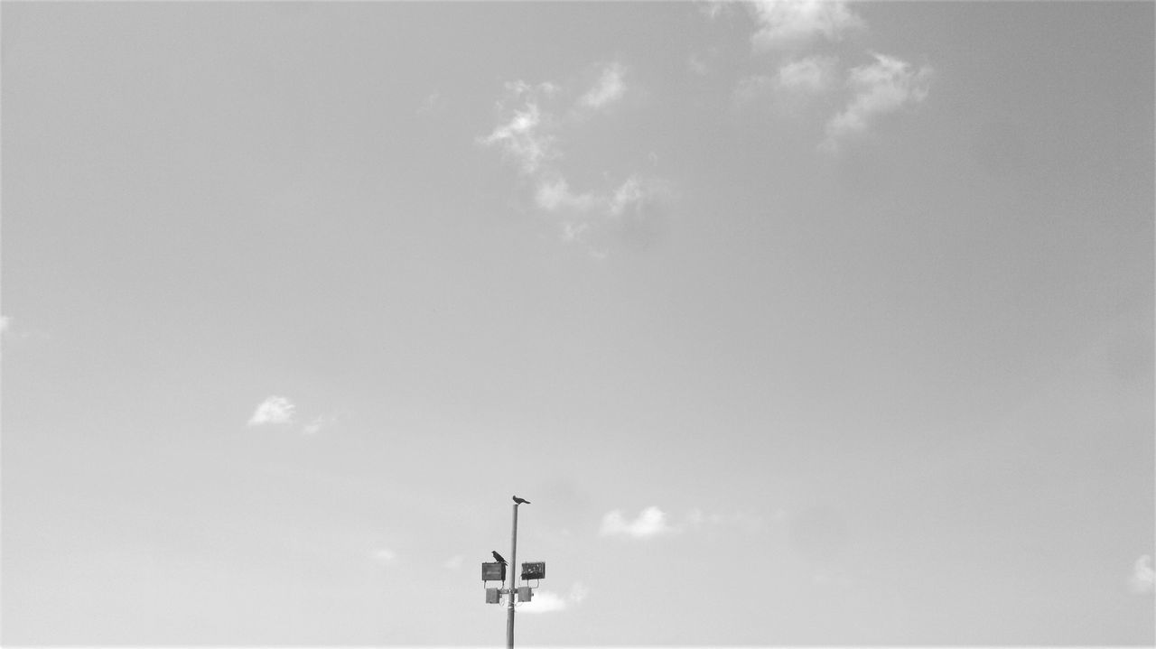 LOW ANGLE VIEW OF FLOODLIGHT AGAINST CLOUDY SKY