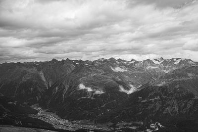 Scenic view of mountains against cloudy sky