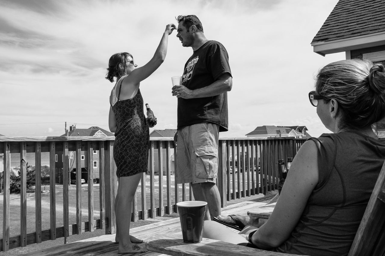 lifestyles, casual clothing, leisure activity, building exterior, full length, built structure, sky, standing, person, architecture, railing, young adult, young men, togetherness, three quarter length, cloud - sky, boys