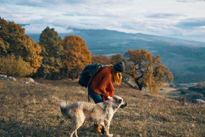 Full length of man with dog on mountain