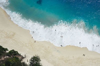 High angle view of beach and sea with tourists