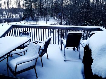 Empty chairs in snow during winter