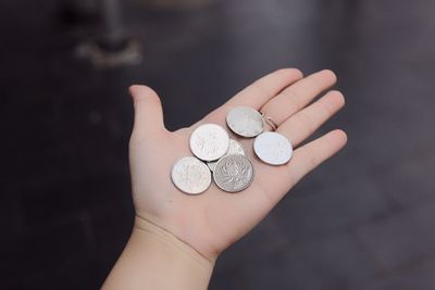 Cropped hand holding coins