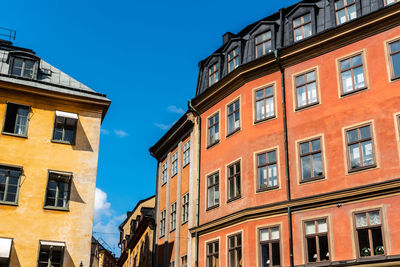 Low angle view of buildings against blue sky