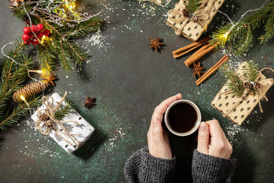 High angle view of woman holding coffee cup