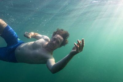 Young man swimming in sea