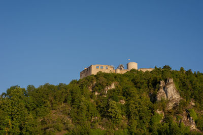 Low angle view of fort against clear blue sky