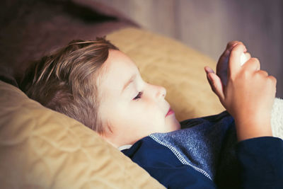 Boy lying on bed at home