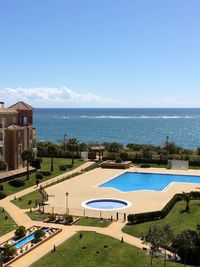 High angle view of swimming pool by sea against sky