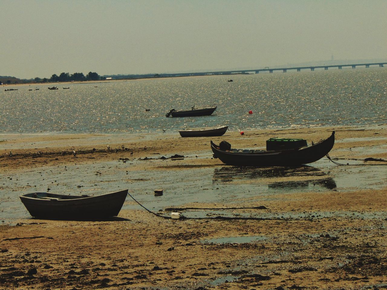 water, nautical vessel, sea, sand, beach, boat, nature, shore, horizon over water, moored, mode of transport, transportation, scenics, beauty in nature, outdoors, day, clear sky, no people, longtail boat, sky