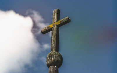 Low angle view of cross against blue sky