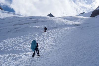 People on snowcapped mountain during winter