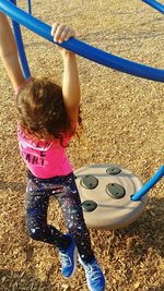 Girl playing on slide at playground