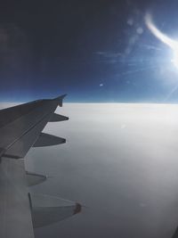 Close-up of airplane wing against sky