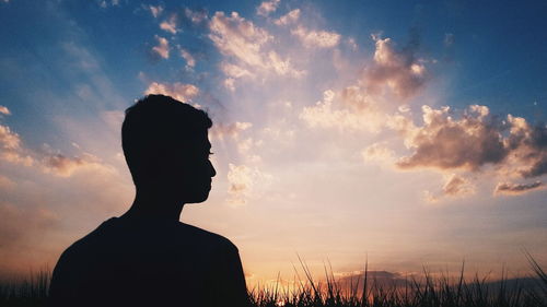 Silhouette of person standing in field
