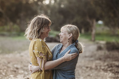 Lifestyle portrait of adult mother and senior mother looking at each o