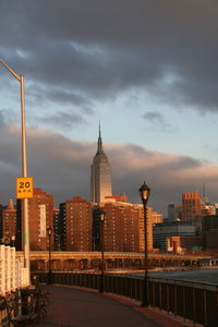 Buildings in city against cloudy sky