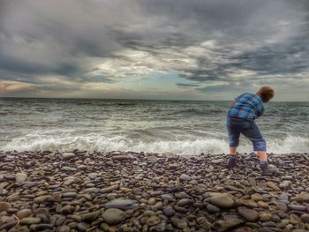 Scenic view of sea against cloudy sky