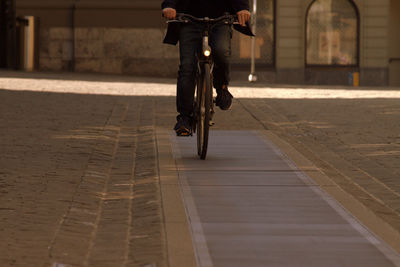 Low section of man riding bicycle