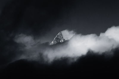 Low angle view of cloud and mountain against sky