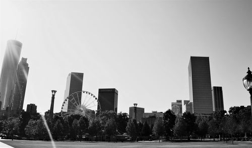 Modern buildings in city against clear sky