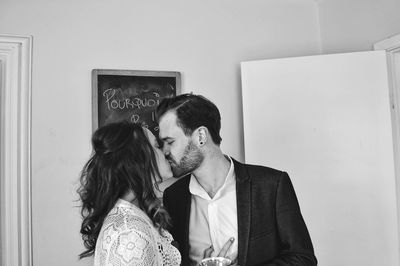 Couple kissing while standing at home