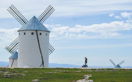 Traditional windmill on field against sky