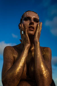 Woman portrait in gold glitters