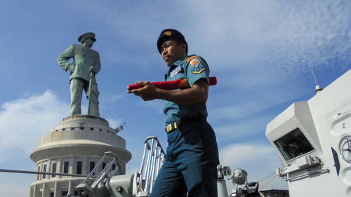 Low angle view of statue against sky