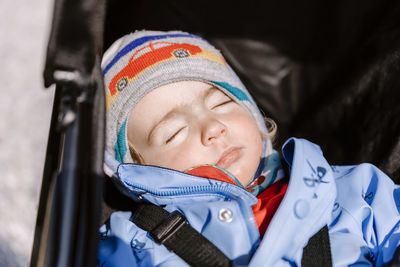 Close-up cute girl sleeping in stroller