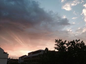 Low angle view of building against cloudy sky