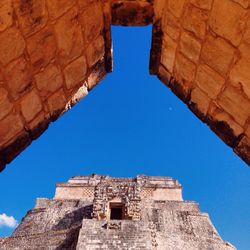 Low angle view of built structure against clear blue sky