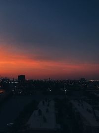 High angle view of illuminated buildings against sky during sunset