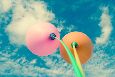 Low angle view of balloons against sky