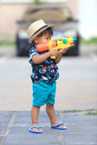 Cute boy wearing hat standing outdoors