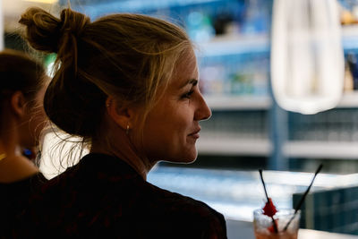 Close-up portrait of young woman looking away