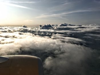 Airplane flying over cloudscape against sky