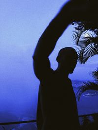 Silhouette of woman against wall