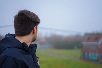 Portrait of young man against sky