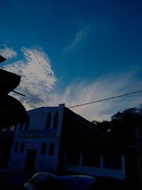 Low angle view of buildings against sky at sunset