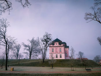 Church by building against sky