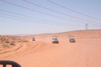 Cars on road against clear sky