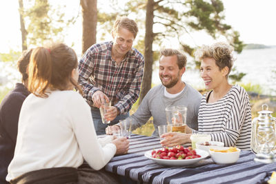 People enjoying while having lunch at lakeshore