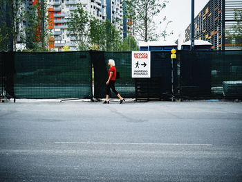 Full length of man walking on road