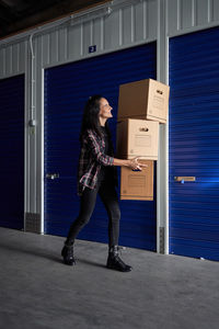 Full length of woman standing at entrance of building