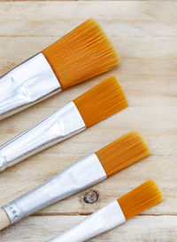 Rustic surface with new and clean, soft bristled paintbrushes and ample copy space